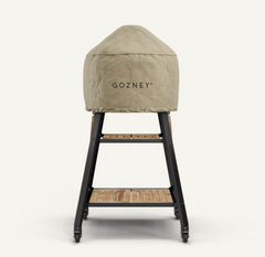 A beige textured cover with the brand name 'GOZNEY' printed on the front, draped over a black metal and wood-tiered cart, shown against a solid off-white background.