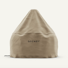 A beige outdoor grill cover by Gozney, shown on a clean off-white background. The brand name 'GOZNEY' is printed in black on the front center of the cover.