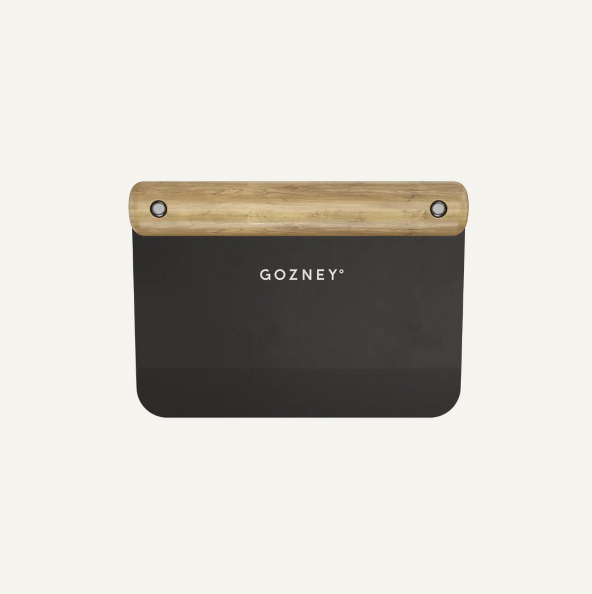 A Gozney kitchen scraper dough cutter with a matte black metal body and a natural light wood handle, shown against a solid off-white background.