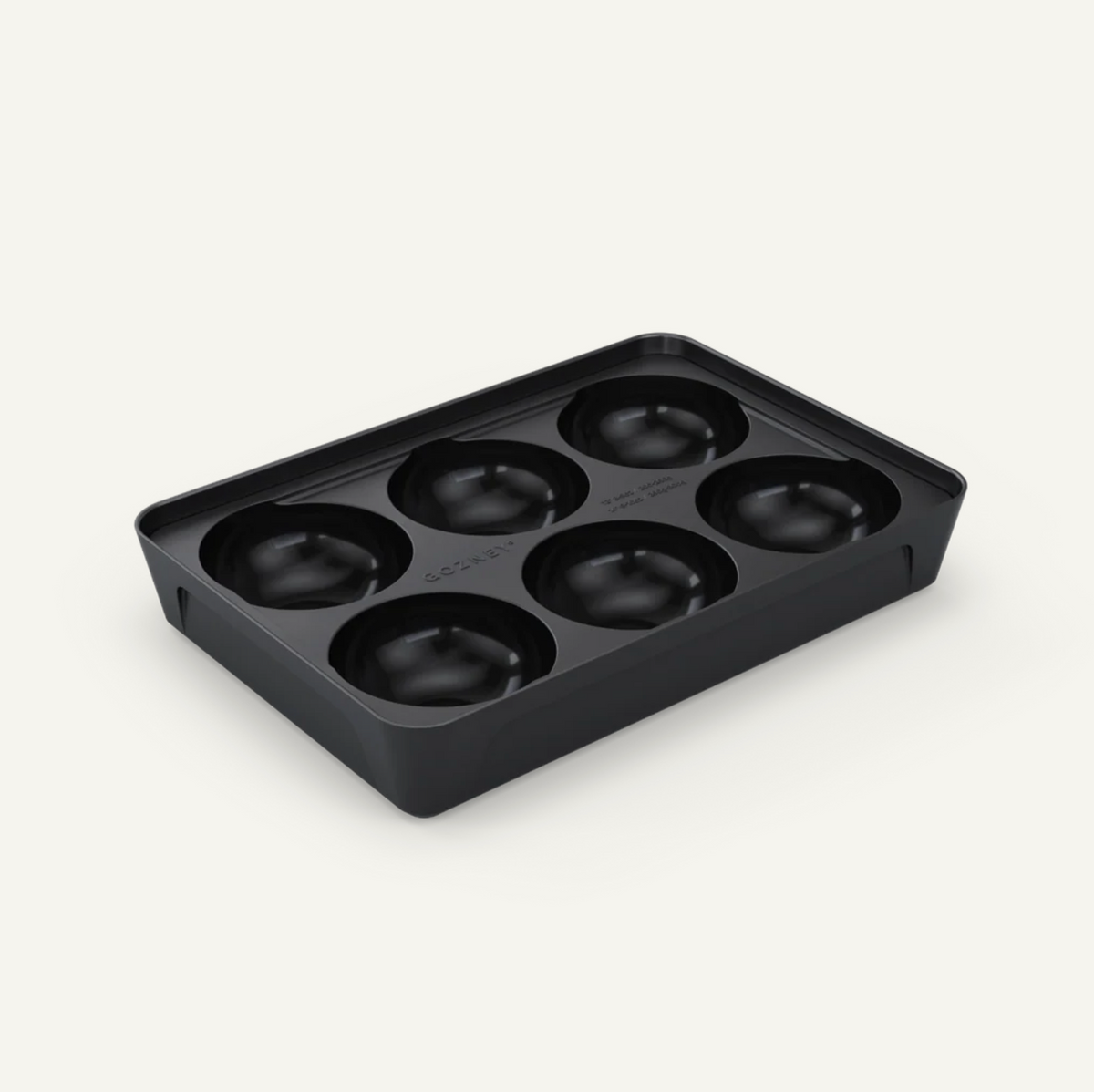Black silicone mold with six round cavities on a white background
