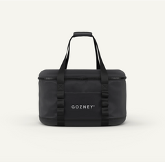 A black Gozney duffel bag with dual top handles, a top zipper, and a front pocket with the brand name 'GOZNEY' printed in white, set against a plain off-white background.